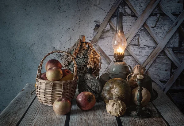 Autumn still life with fruits and vegetables by the light of a kerosene lamp