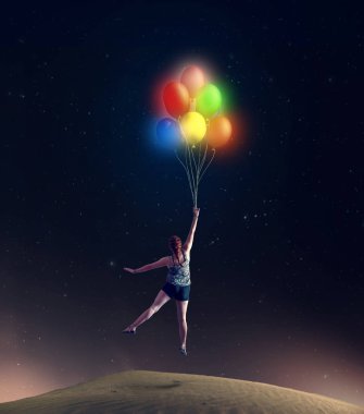 Renkli balonlar tutan yerden alarak genç kız.