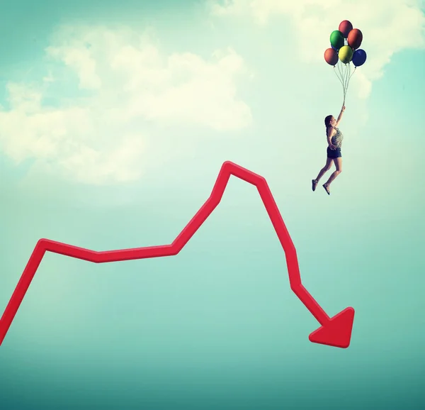 Woman flying with balloons off a decreasing graph.