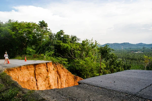 Washout: rain flood damaged badly washed out road in Thailand