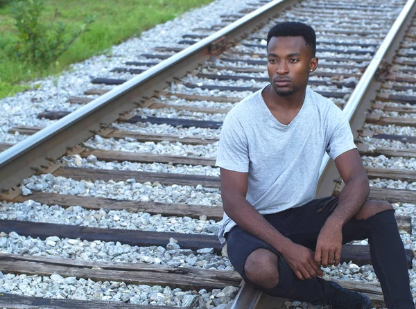 Young African Man Portrait Sitting Railroad Rail Train Track — Stock Photo, Image