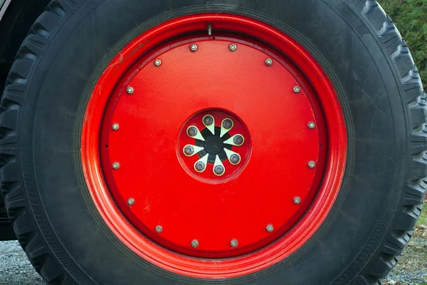 Red wheel tire tractor large metal rim — Stock Photo, Image