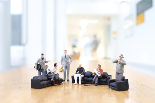 mini of figure people closing deal in office