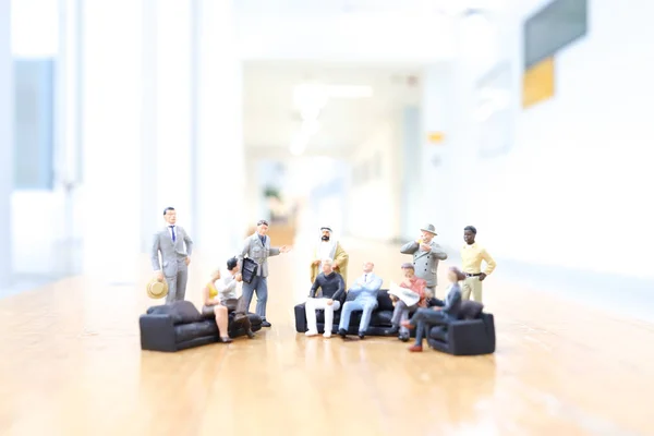 mini of figure people closing deal in office