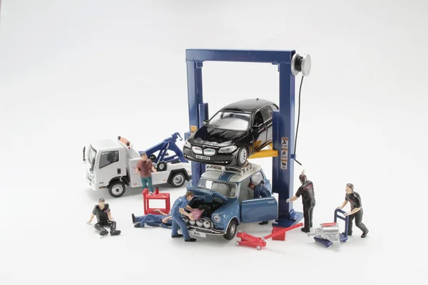 a Scale tiny of model Car lift with figure