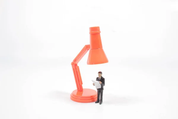 the mini figure reads under the big lamp