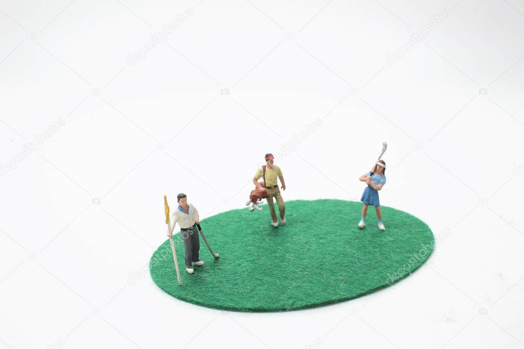 a mini Figures playing golf on the green grass