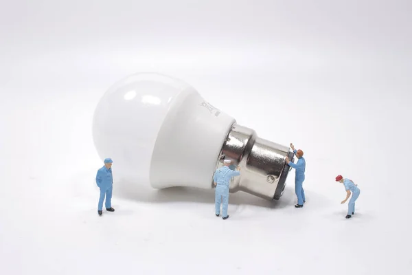 a creative idea, power or energy generator concept, miniature people