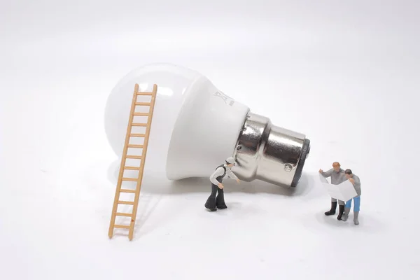 a creative idea, power or energy generator concept, miniature people