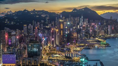 Canlı bir şehir manzarası, hareketli bir liman, parlayan gökdelenleri gösteriyor.,