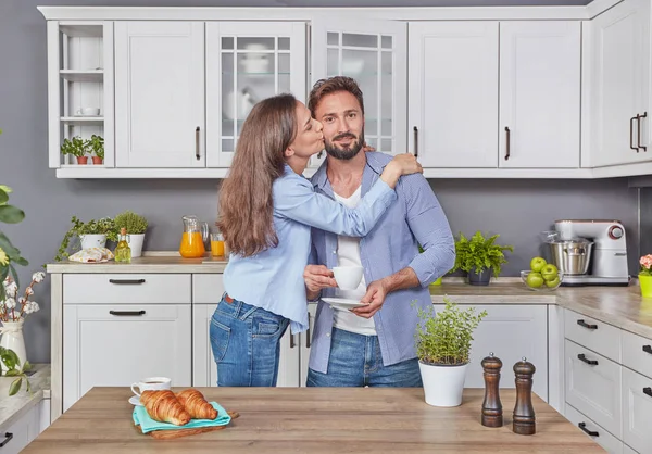 Young couple in love in the kitchen enjoying a coffee