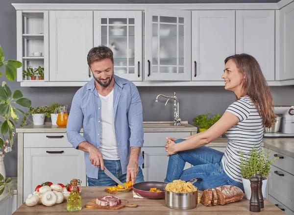 Happily married couple cooking together in the kitchen