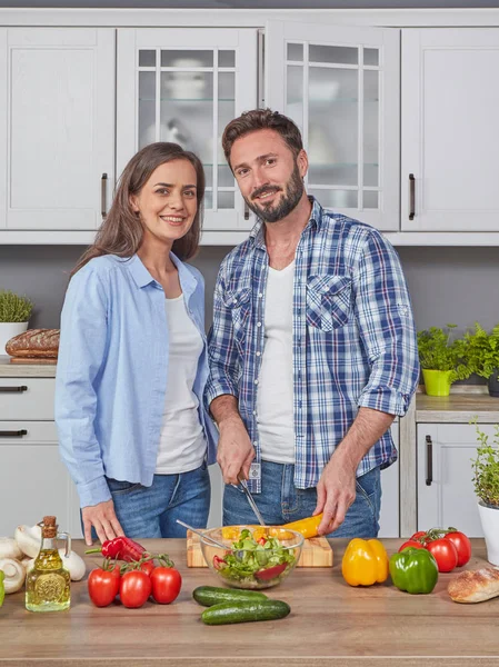 Happily married couple cooking together in the kitchen