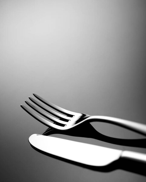 Fork and knife on black