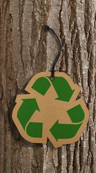 Recycle tag on bark tree