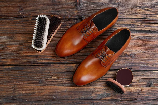Men leather shoes and care products on wood