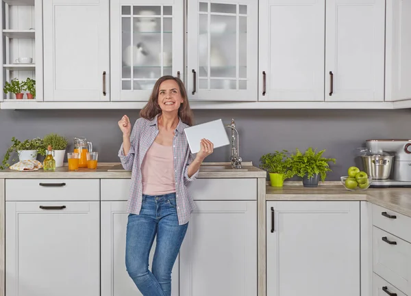 Genç kadın mutfakta dijital tablet ile