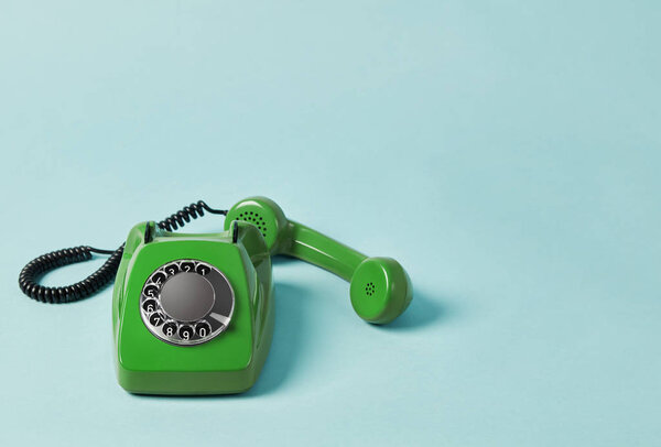 Vintage telephone on colored background
