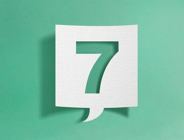 Speech bubble with number 7 on green background