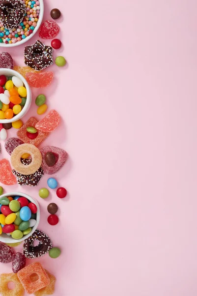 Colored candy on pink — Stock Photo, Image