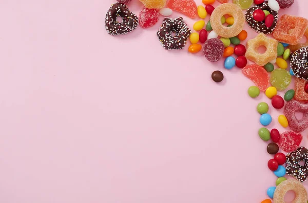 Colored sweets on pink — Stock Photo, Image