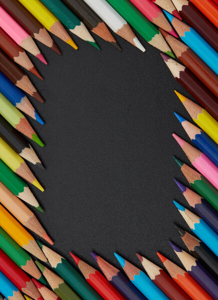 Multi-colored pencils on black background