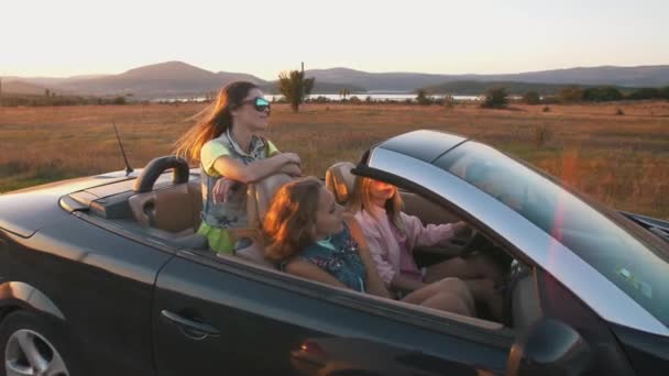 Young women having a fun in a convertible car — 图库视频影像