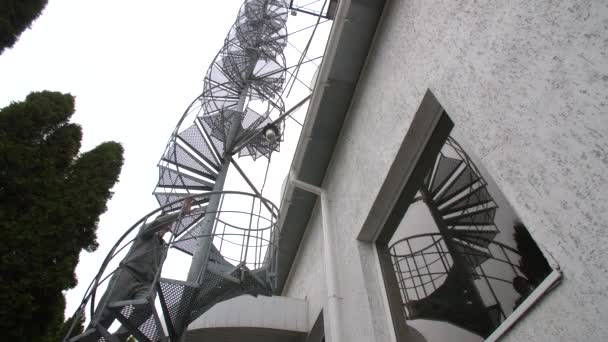 El hombre sube por la escalera de caracol — Vídeo de stock