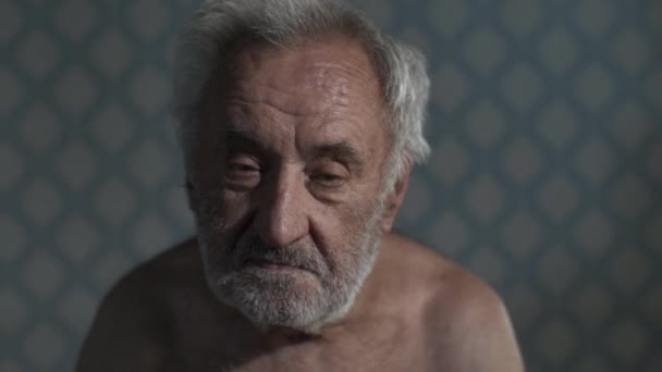 Portret van een oude arme man thuis — Stockvideo