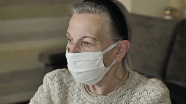 Seniorin mit Gesichtsmaske unter Quarantäne — Stockvideo