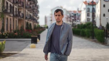 A man pauses mid-step on a street, his expression transforming from thoughtfulness to pure joy as a breakthrough idea strikes him.