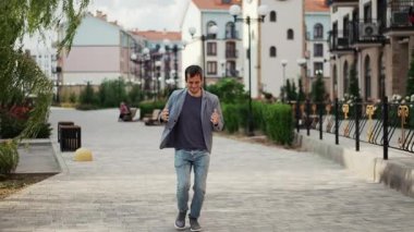 An overjoyed man skips down the street with childlike enthusiasm and radiant happiness.