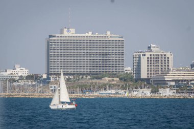 Hilton Otel ve bir tekne ile Tel Aviv sahil mesire (Akdeniz beach) panoramik manzaralı. İsrail, Kasım 2013.