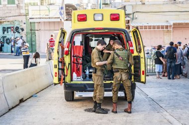 HEBRON, ISRAEL / PALESTINE. September 25, 2018. Ambulance emergency car with Israel army paramedics by the Cave of the Patriarchs in Hebron during the mass pilgrimage on the Jewish holiday of Sukkot. clipart