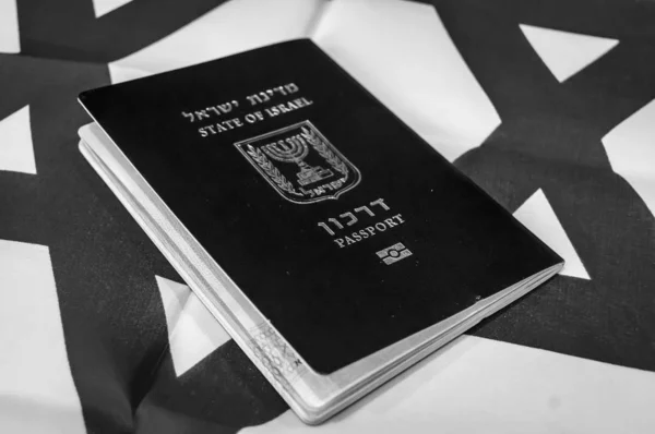 A blue passport of the State of Israel on Israeli flag on the background. Israel citizenship concept, Israeli biometric \