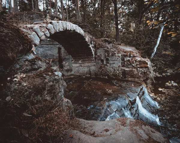 Puente de piedra cruza un arroyo — Foto de Stock