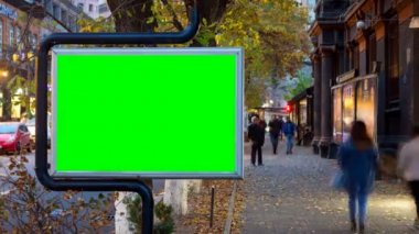 4 k Time Lapse video. Sonbahar şehirdeki insanların yürüme arka planı yeşil ekran ile büyük billboard bulanık.