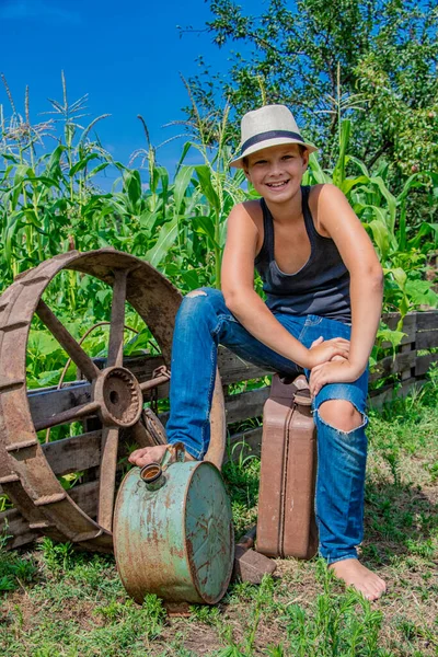 Verano niño en un sombrero de niño en la naturaleza feliz en la naturaleza en el pueblo —  Fotos de Stock