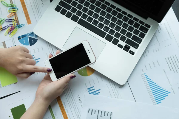Mali belge ve dizüstü bilgisayar işyeri ağındaki smartphone kullanarak iş kadını üstten görünüm