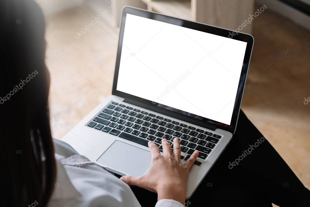 young woman working with laptop computer at home, empty screen display
