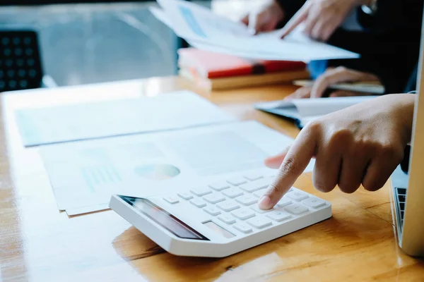 Close up Businessman and partner using calculator and laptop for calaulating finance, tax, accounting, statistics and analytic research concept — Stock Photo, Image