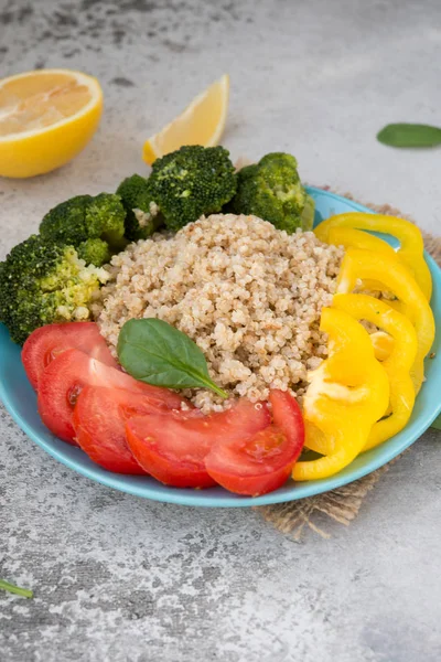 Quinoa salad with broccoli, paprika and tomatoes