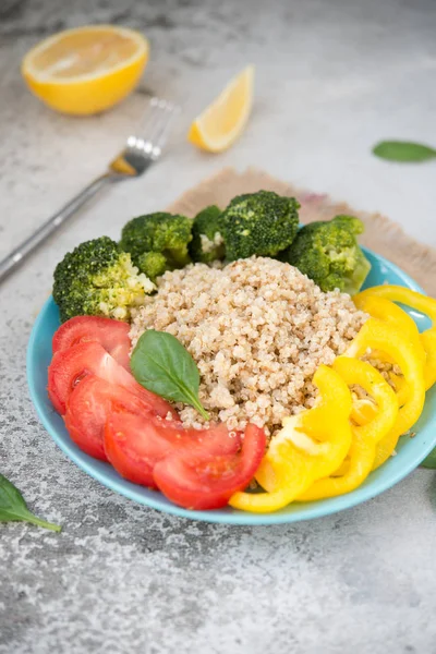 Quinoa salad with broccoli, paprika and tomatoes