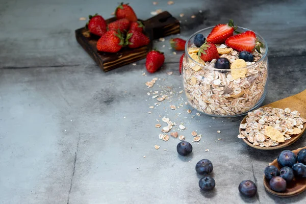Healthy whole-grain muesli with fresh berries on a gray background. Clean food. Healthy diet.