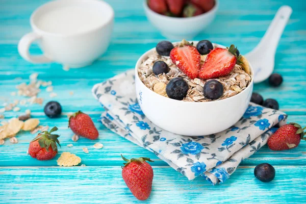 Healthy whole-grain muesli with fresh berries on a light wooden background. Clean food. Healthy diet