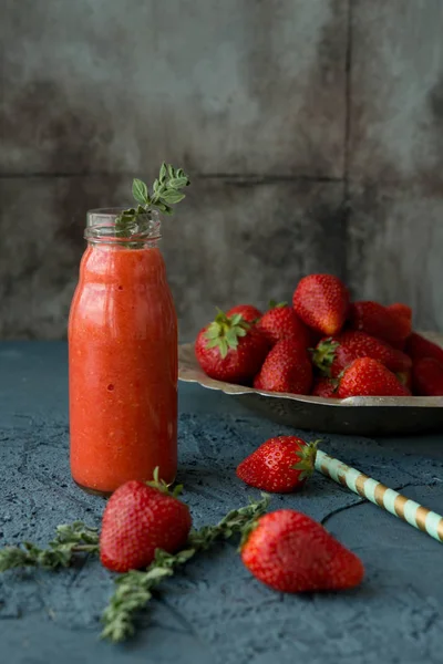 Fresh strawberry smoothie on black background. Live food. Dietary food