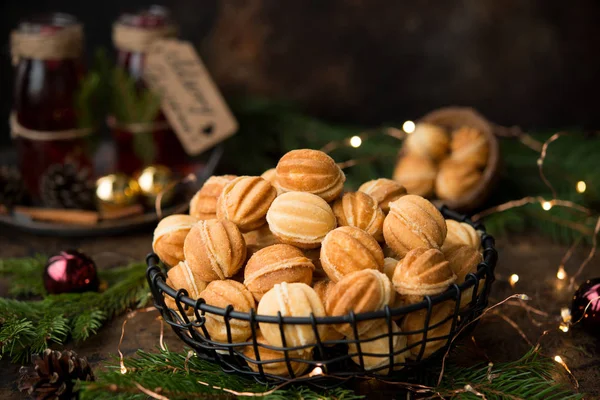 Christmas dessert cookies nuts with boiled condensed milk on a dark background with garlands and Christmas decorations
