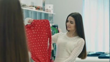 Elbise aynanın karşısında çalışan genç kadına heyecanlı