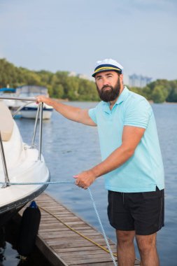 Bir sakallı bir adam denetler tutar bir kablo yat