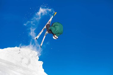 Horizontal shot of a professional male extreme freeride skier jumping from the slope while skiing in the mountains copy space lifestyle x-treme sport dangerous skills rider athlete. clipart